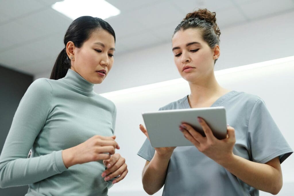 Two nurses looking at an iPad