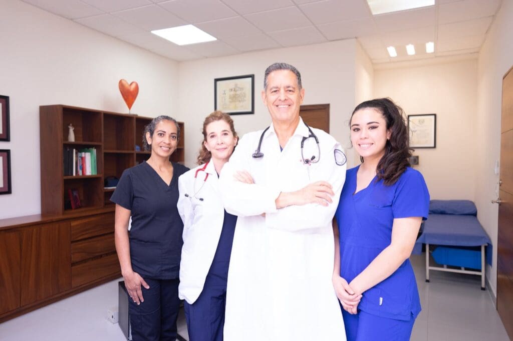 4 healthcare professionals smiling at the camera