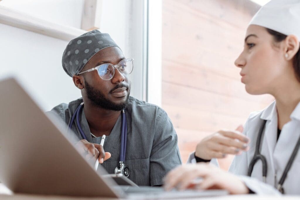 male doctor looking at a female doctor who is talking to him